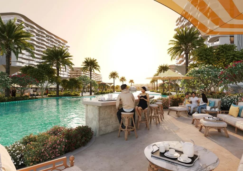 Valencia at DAMAC Lagoons — courtyard pool, wave-balcony towers, and outdoor lounge at golden hour